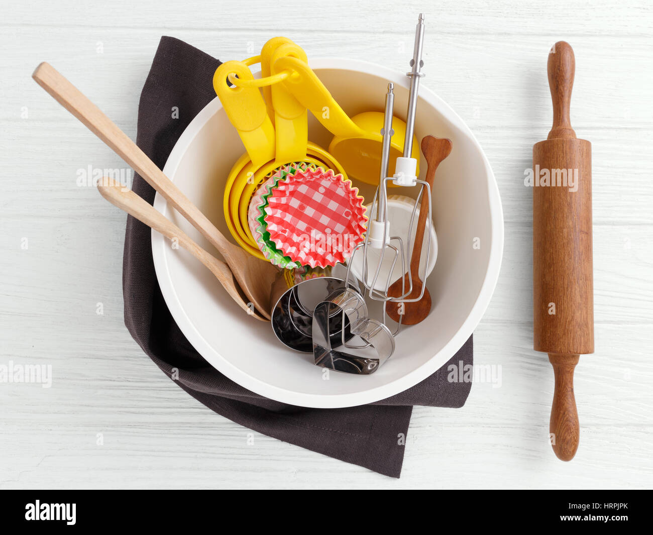 https://c8.alamy.com/comp/HRPJPK/baking-tools-and-utensils-in-mixing-bowl-on-white-wooden-background-HRPJPK.jpg