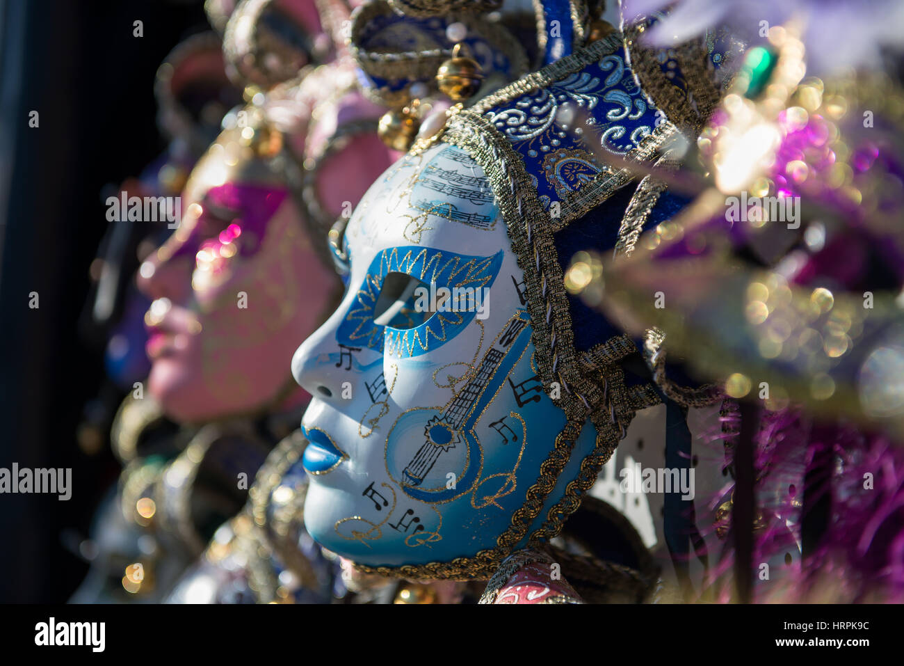 Golden Venetian Carnival Mask. Wonderful mask participant of the carnival celebrations in St. Mark's basin. Blurred background. Stock Photo