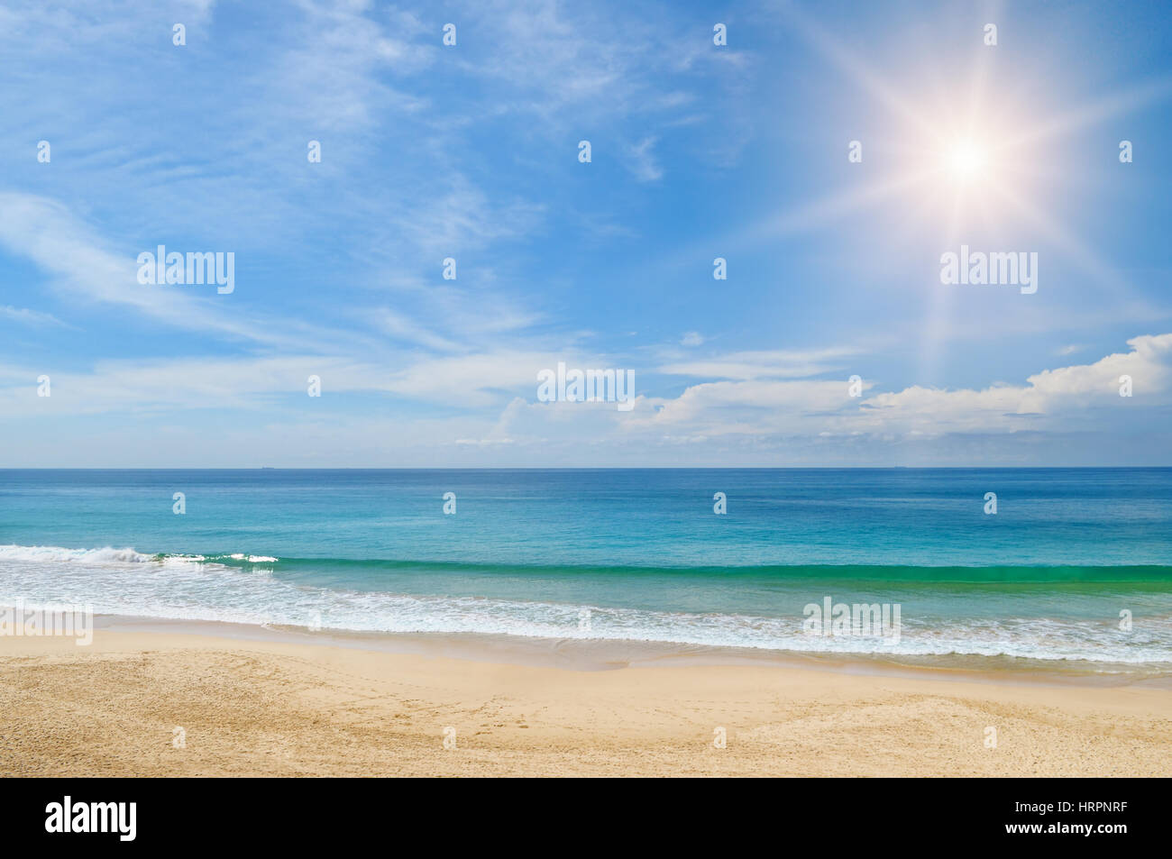 ocean, sandy beach and blue sky Stock Photo - Alamy