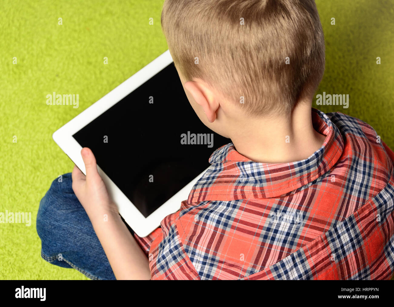 child keeps tablet in hands Stock Photo