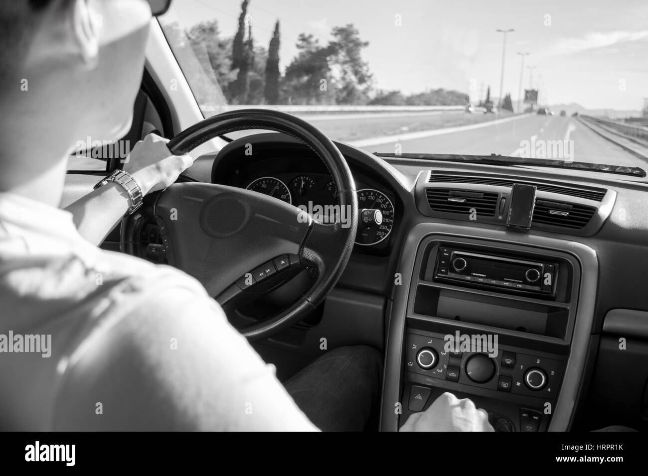 Guy driving on open road ( view from interior ) Stock Photo