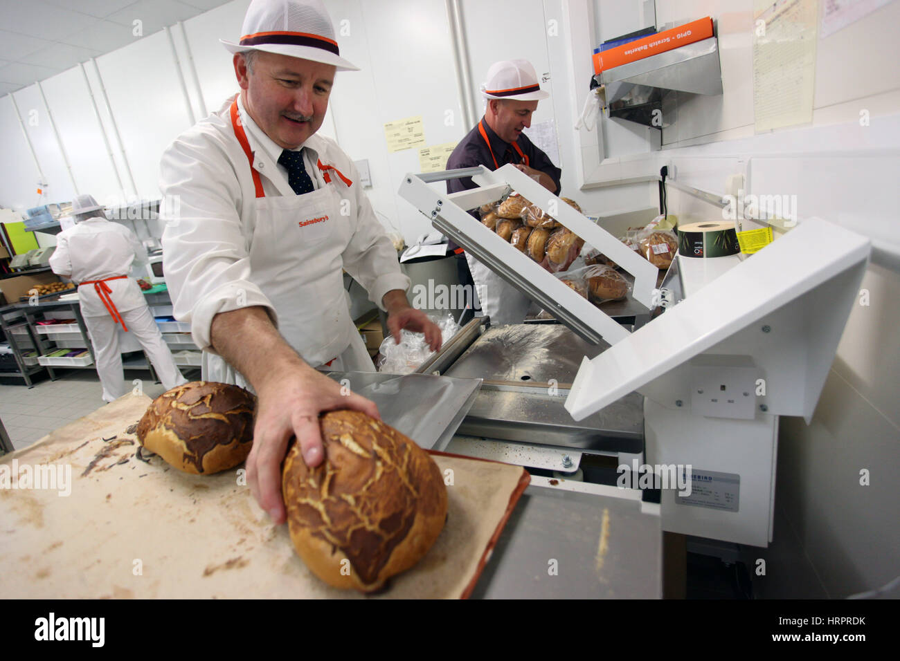 Sainsburys supermarket in Colne , UK. Two men work in the bakery Stock