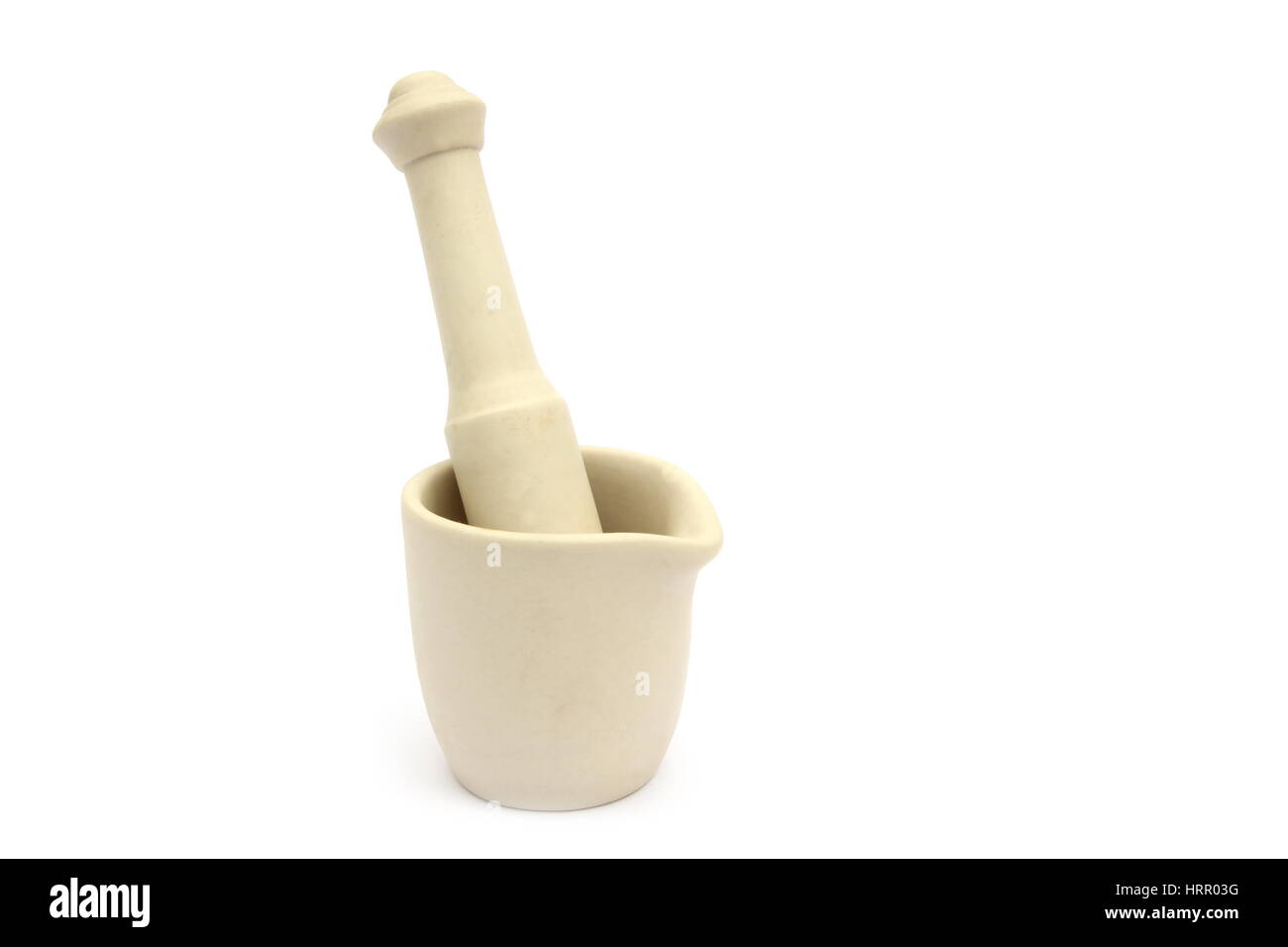 Traditional porcelain mortar and pestle, used to grind spices, on white