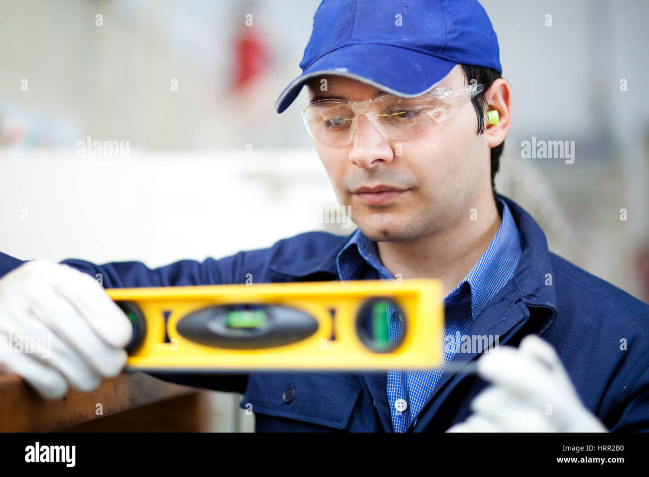 Worker using a level Stock Photo - Alamy