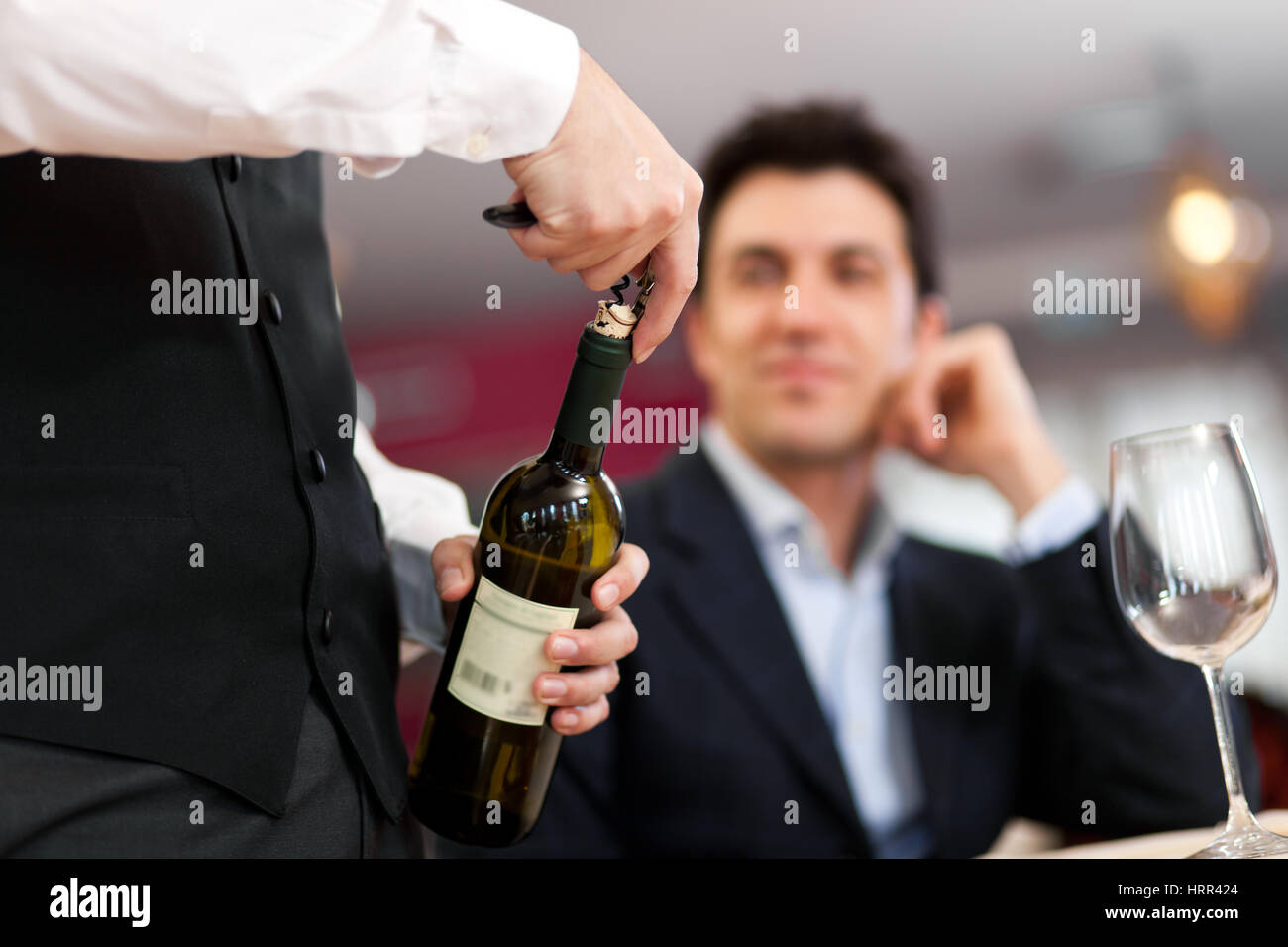Waiter serving wine in a restaurant Stock Photo Alamy