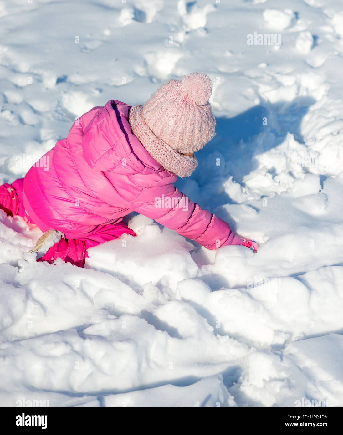 Little girl in snow, playing Stock Photo Alamy