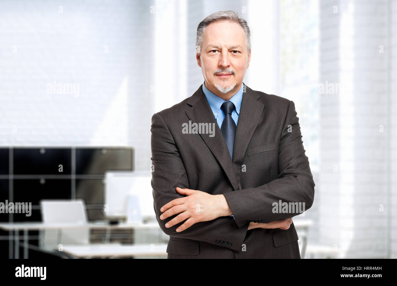 Mature businessman portrait in his office Stock Photo - Alamy