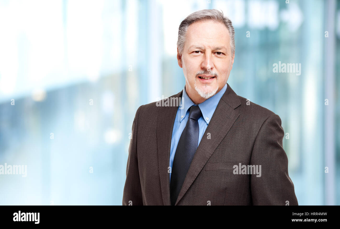 Mature businessman portrait in the office Stock Photo - Alamy
