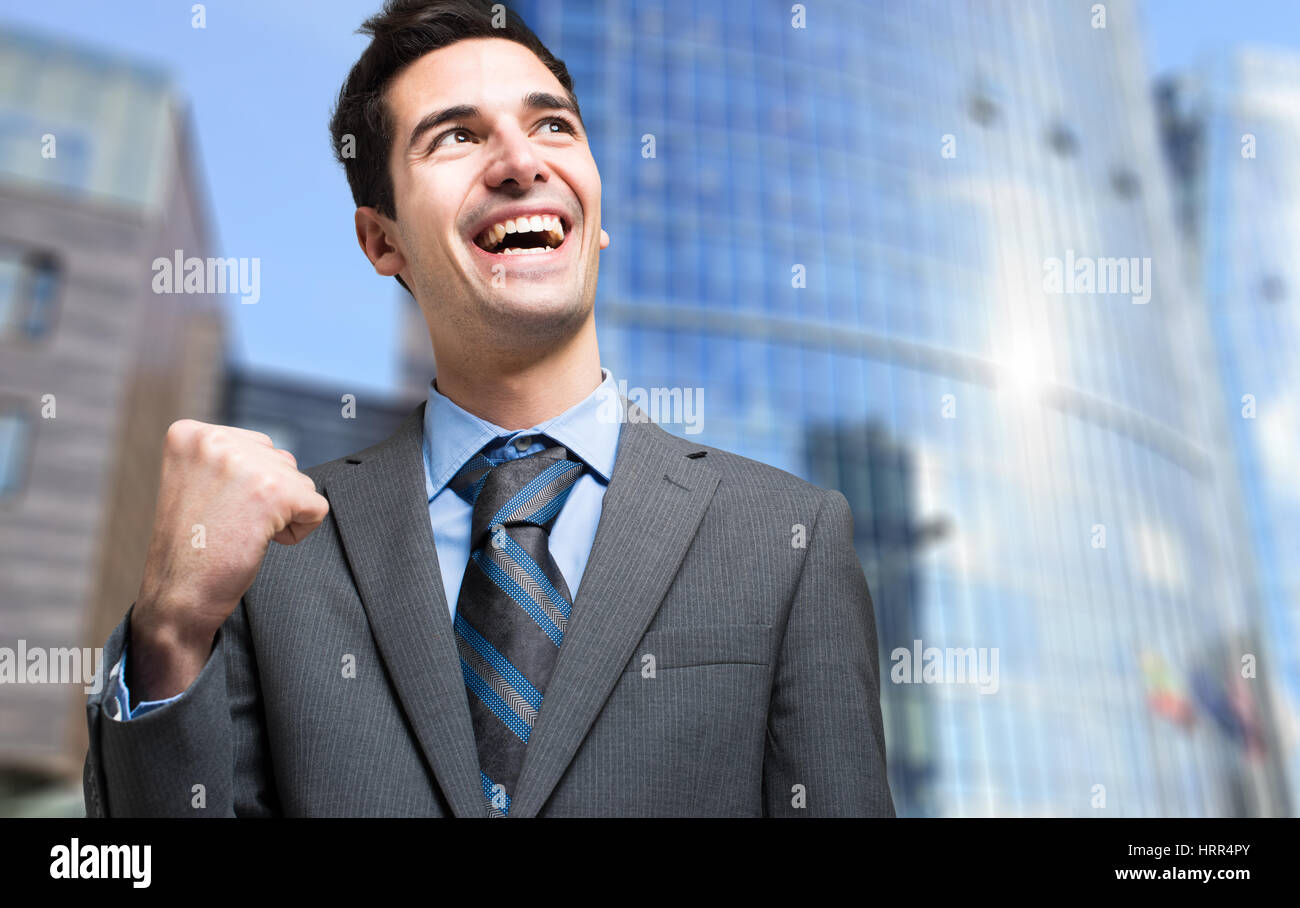 Successful businessman raising his fist Stock Photo - Alamy