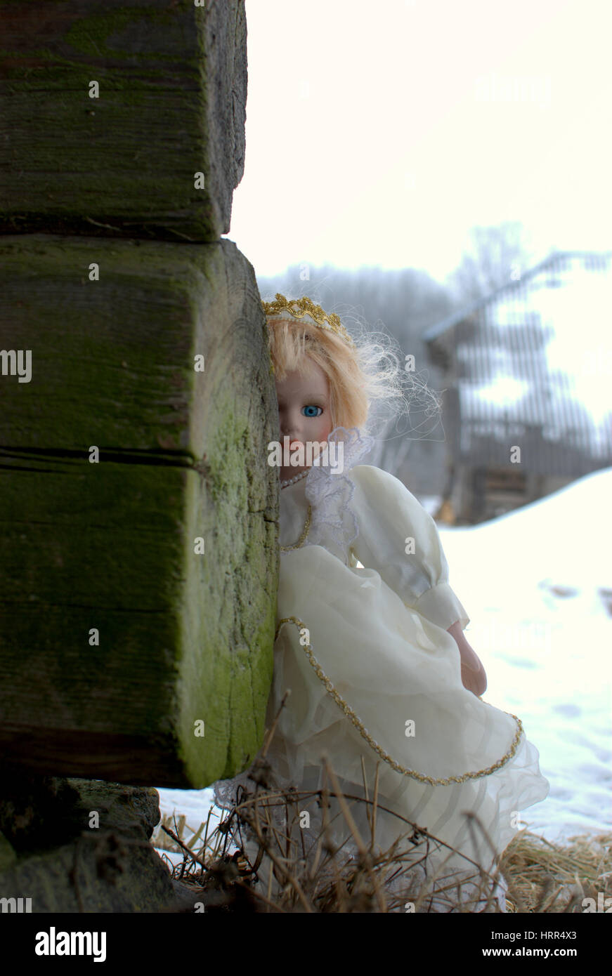 An old doll decided to travel herself arround old farmstead Stock Photo
