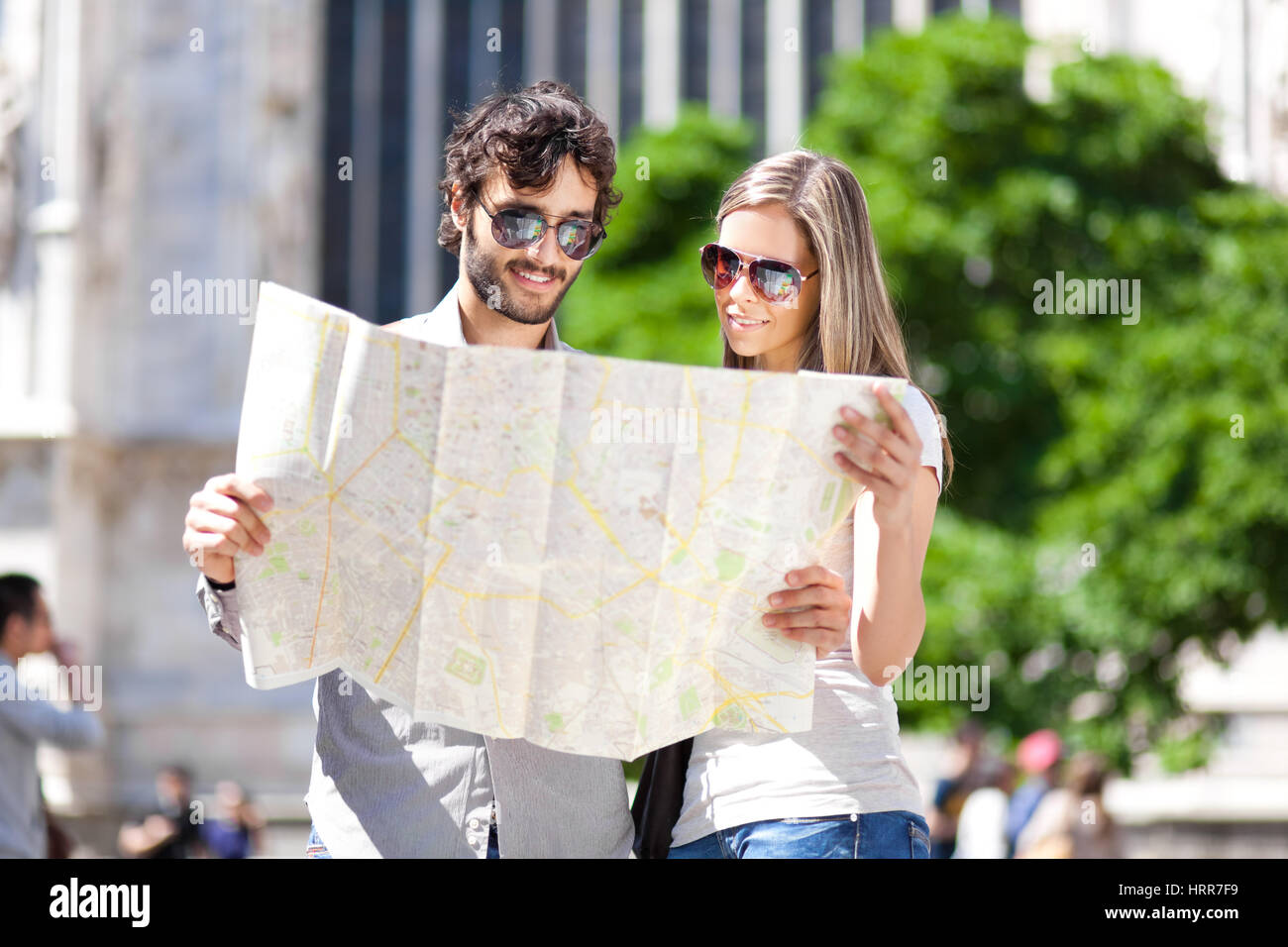 Couple of young tourists reading a map in the city Stock Photo