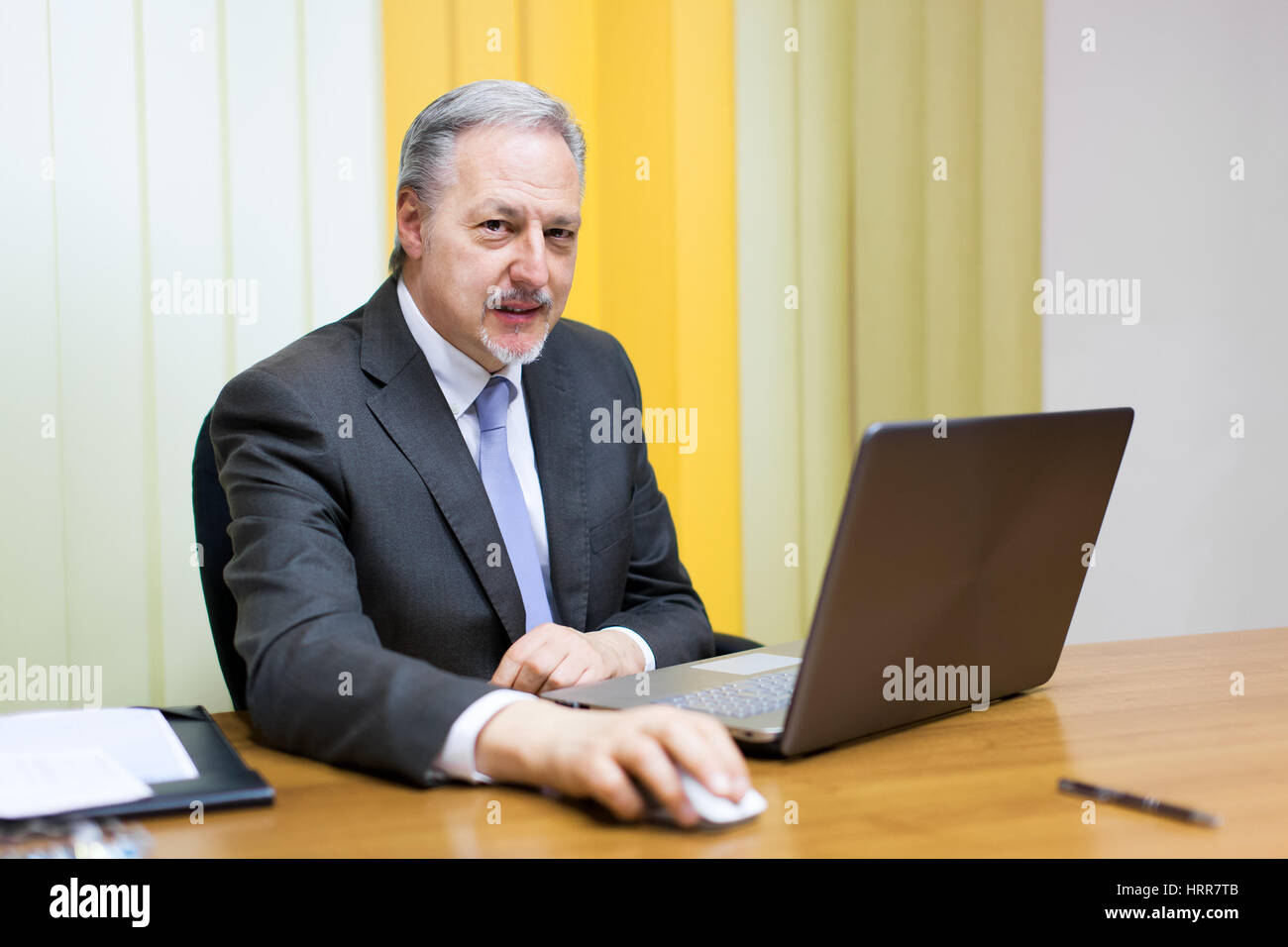 Portrait of a smiling senior businessman sitting in his office Stock Photo