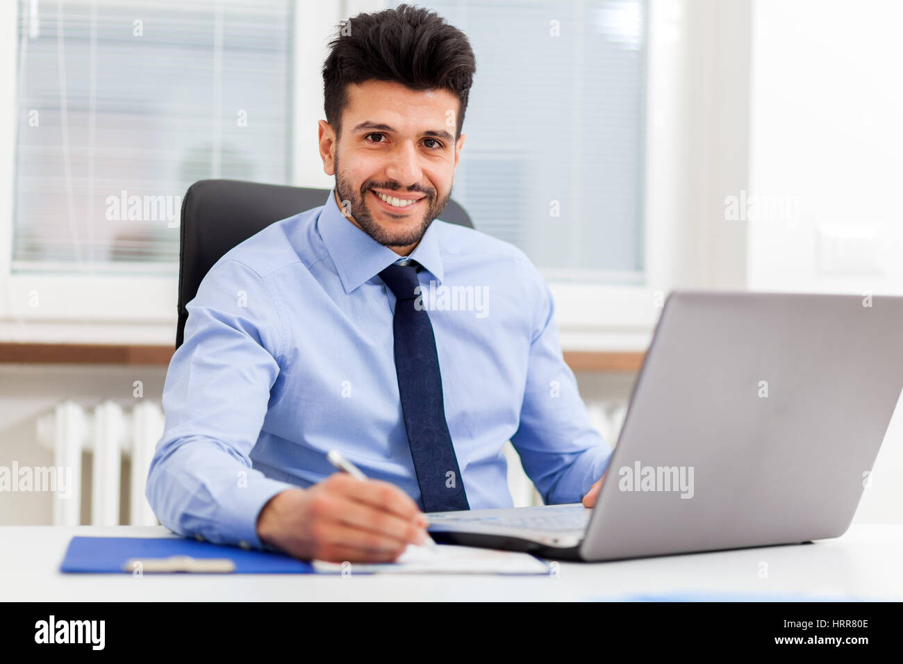 Handsome businessman at his desk in the office Stock Photo Alamy