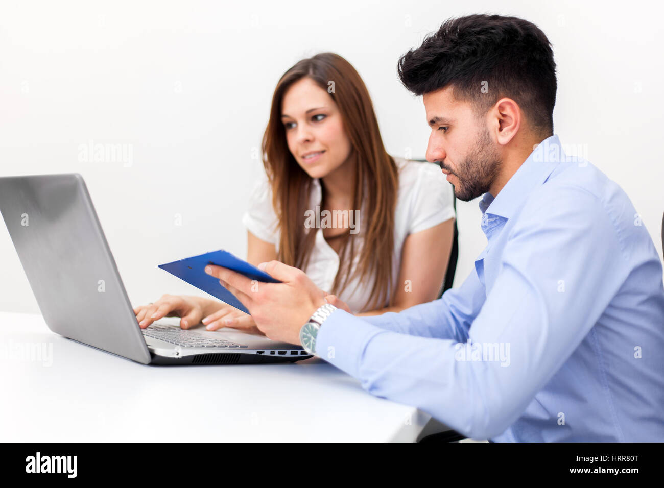 Smiling business people using a computer in their office Stock Photo ...