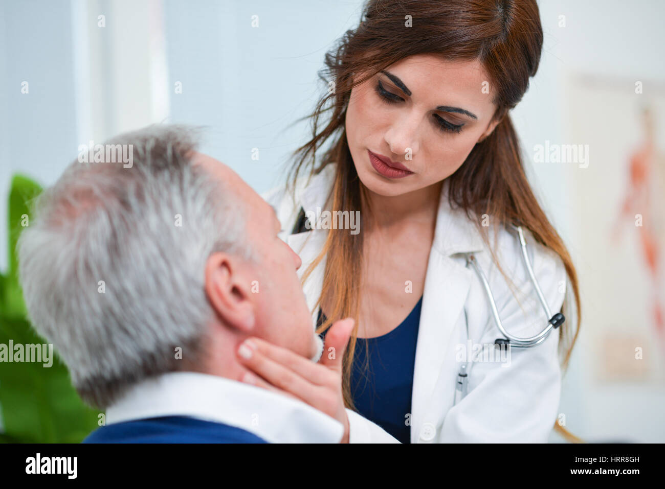 Doctor checking the lymph nodes size of her patient Stock Photo
