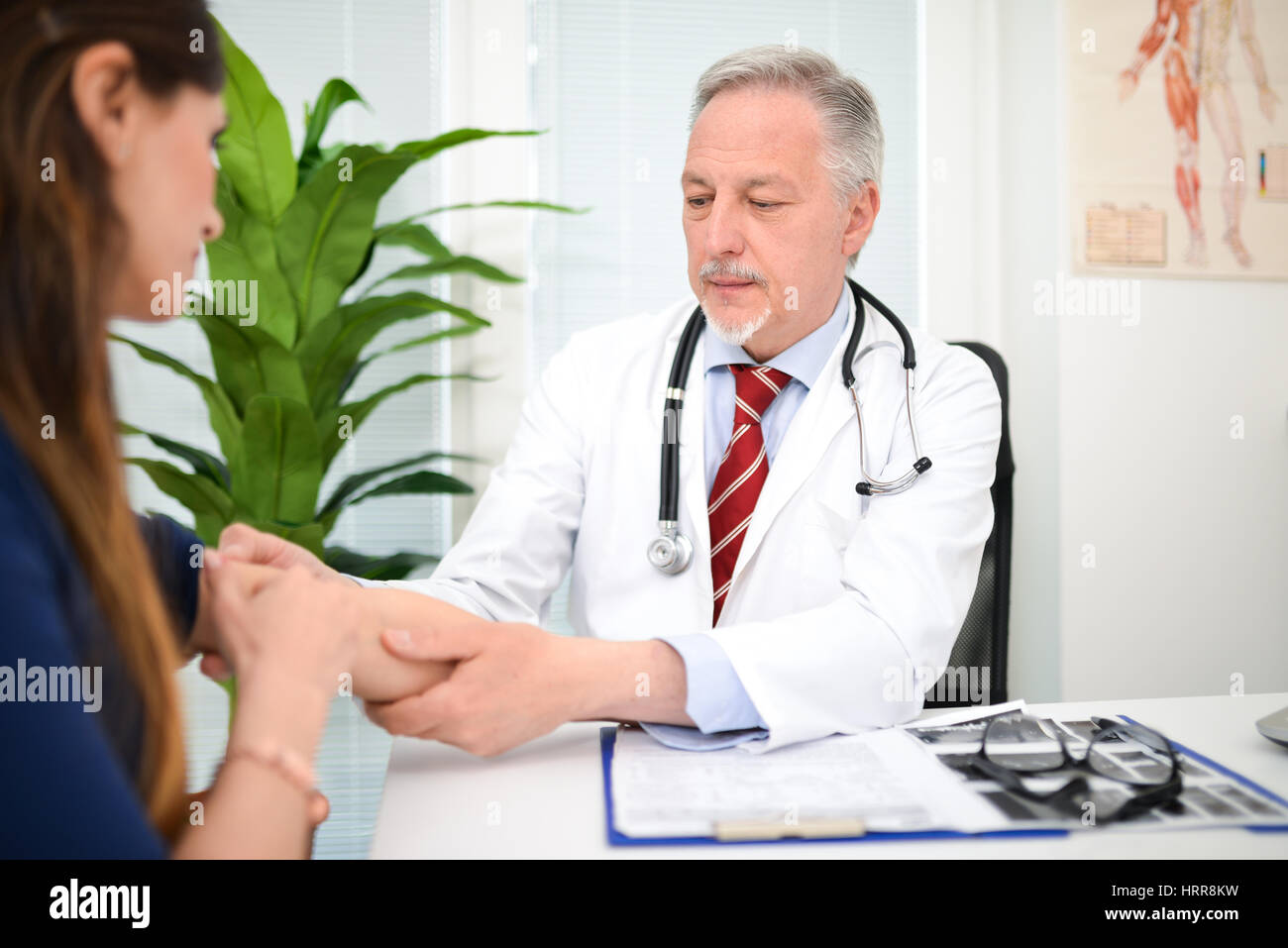 Doctor checking a patient's arm Stock Photo Alamy
