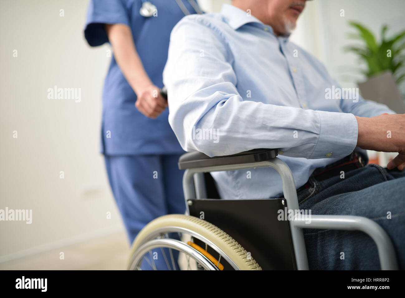 Nurse pushing an injured patient on a wheelchair Stock Photo - Alamy