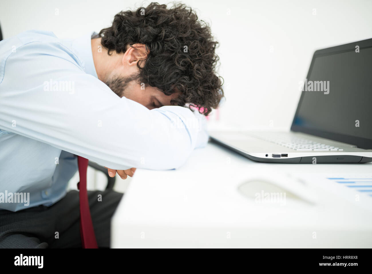 Sad Businessman Lying His Face Down On His Desk Stock Photo