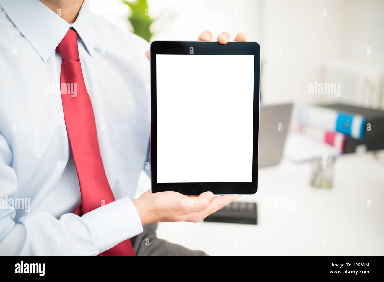 Man holding a tablet with a blank screen Stock Photo - Alamy