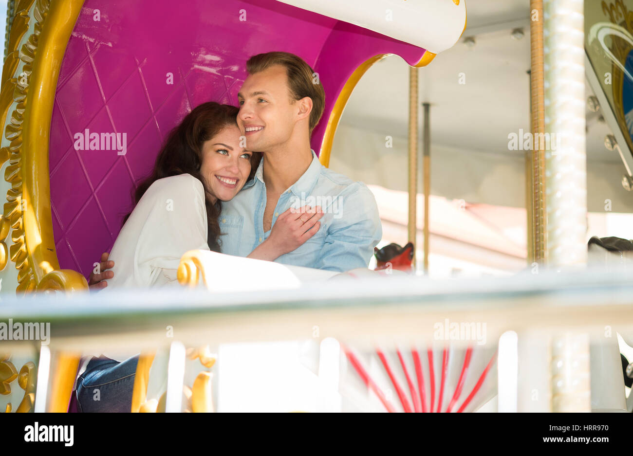 Young happy couple having fun in an amusement park Stock Photo - Alamy