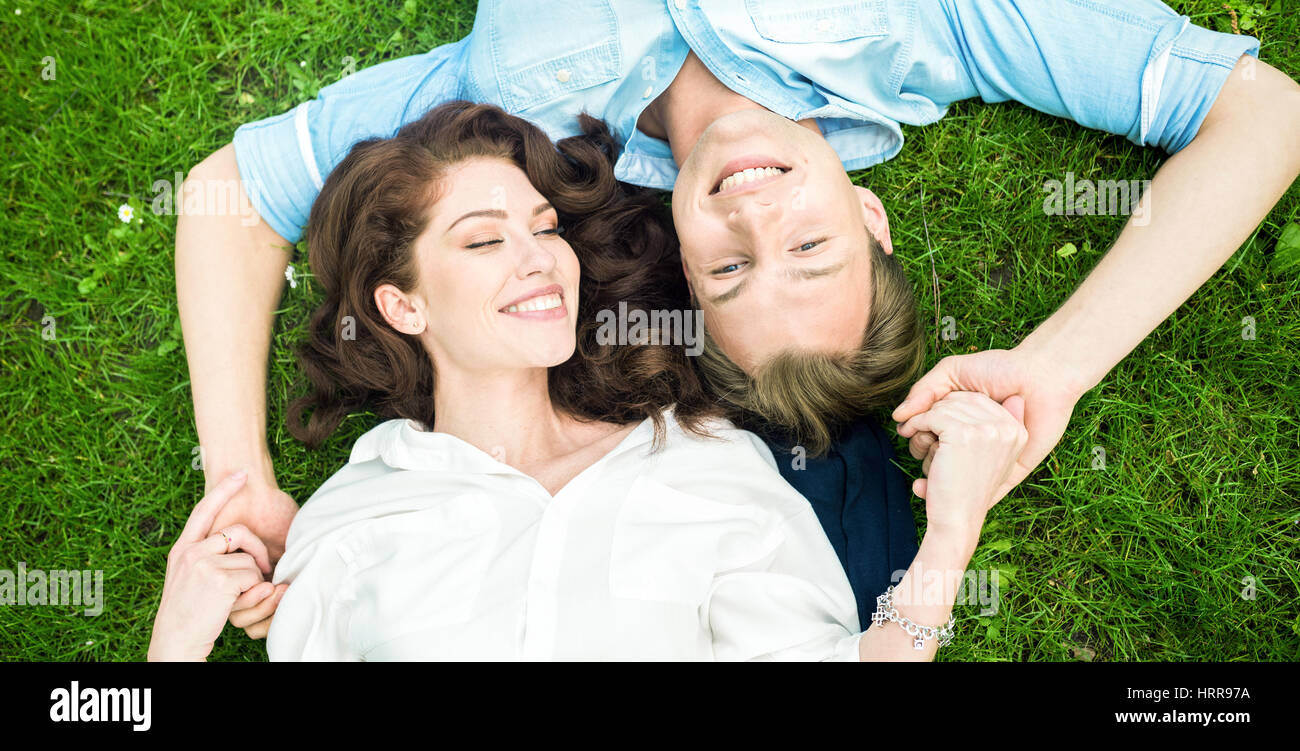 Couple in love lying down on the grass Stock Photo Alamy