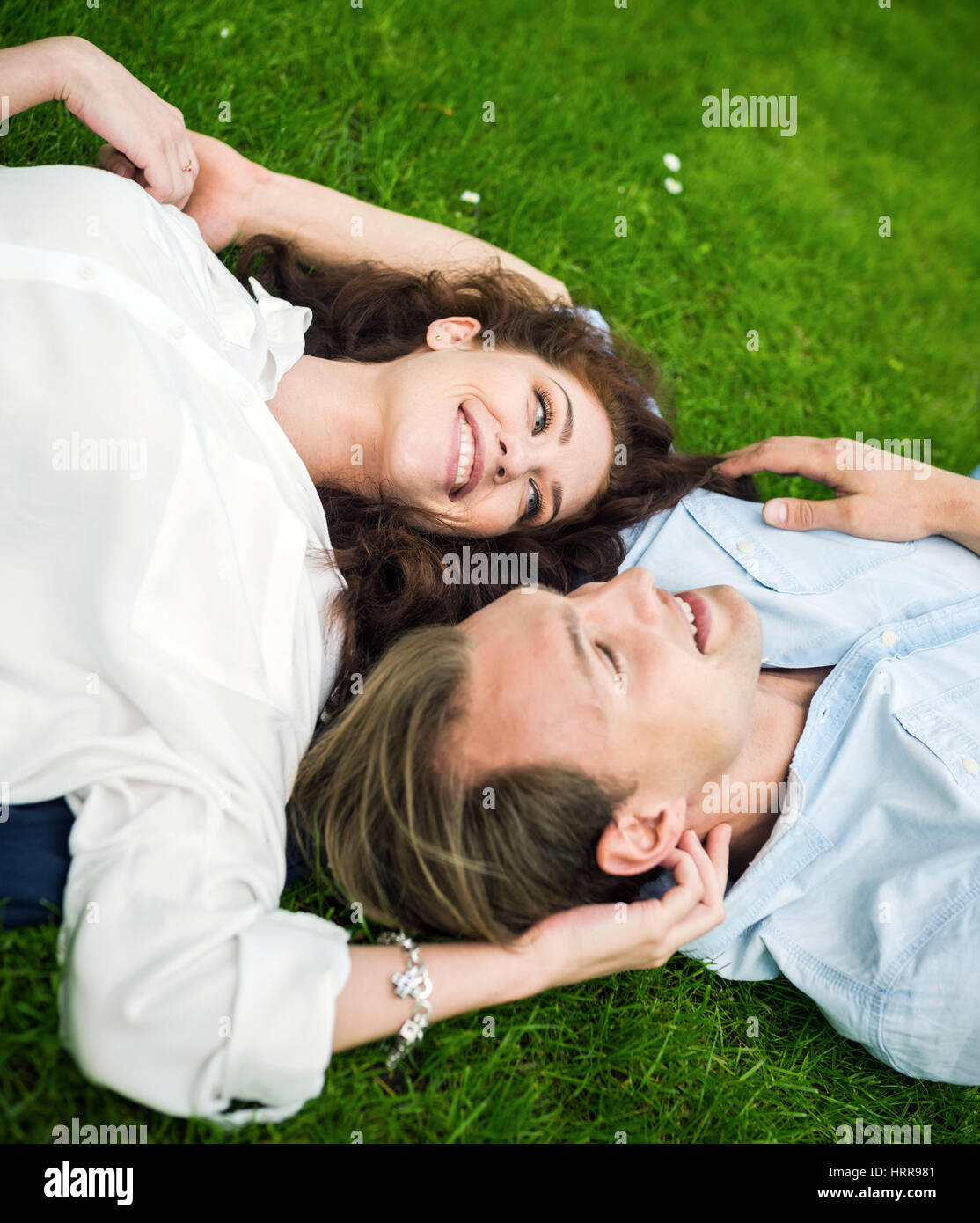 Couple in love lying down on the grass Stock Photo Alamy