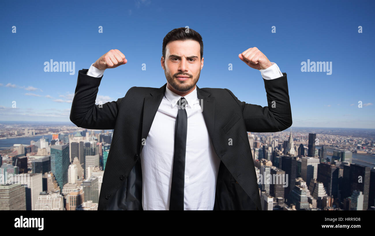Happy businessman raising his arms in front of a big city Stock Photo ...