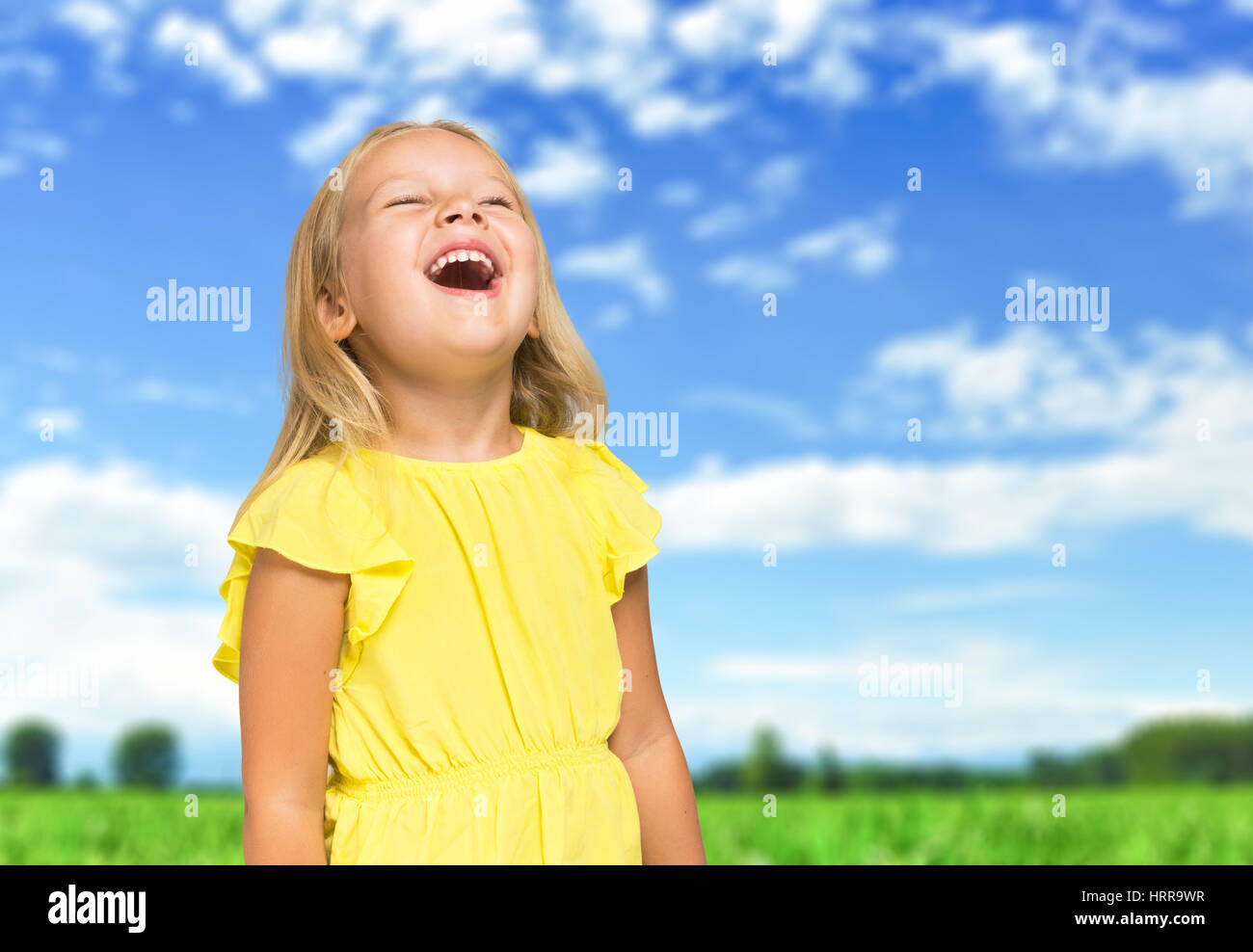 Very happy child laughing outdoors Stock Photo - Alamy