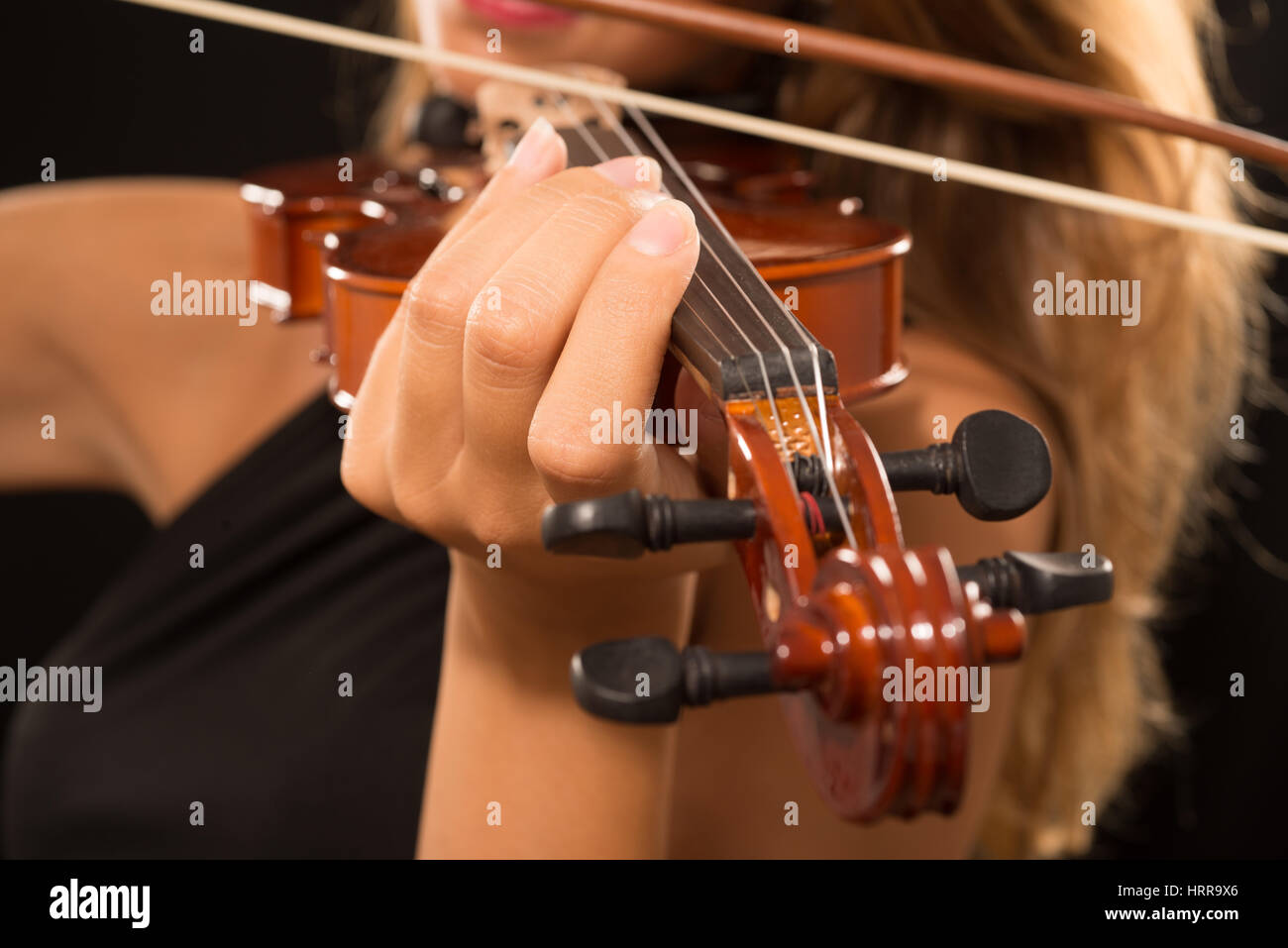 Detail of a woman playing her violin Stock Photo