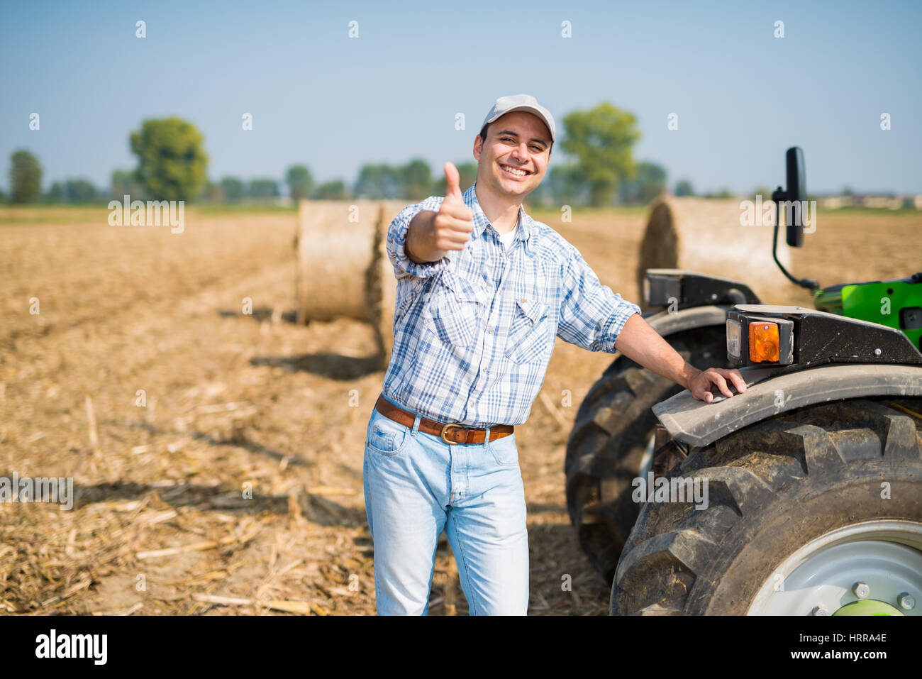 Portrait of a smiling farmer giving thumbs up Stock Photo - Alamy