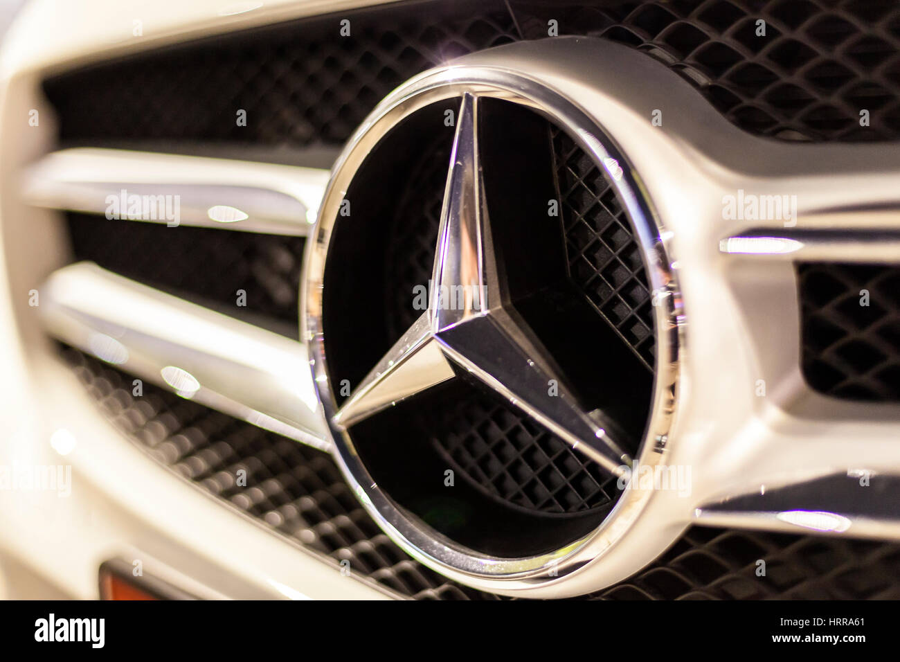 ABU DHABI, UAE - NOV 26, 2016: Mercedes Benz company logo on a car illuminated at night Stock Photo