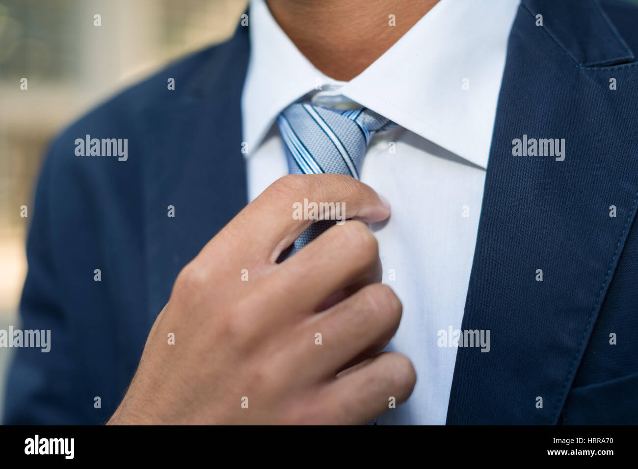 Detail of a businessman adjusting his tie Stock Photo