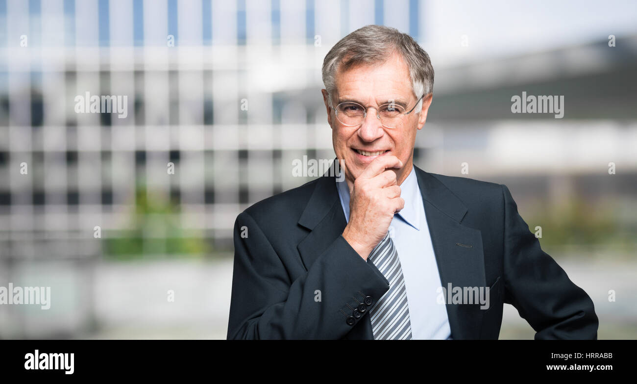Smiling businessman in front of his office. Wide image Stock Photo - Alamy