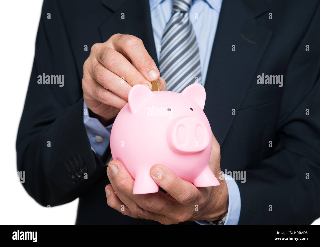 Man putting money in a piggy bank Stock Photo - Alamy