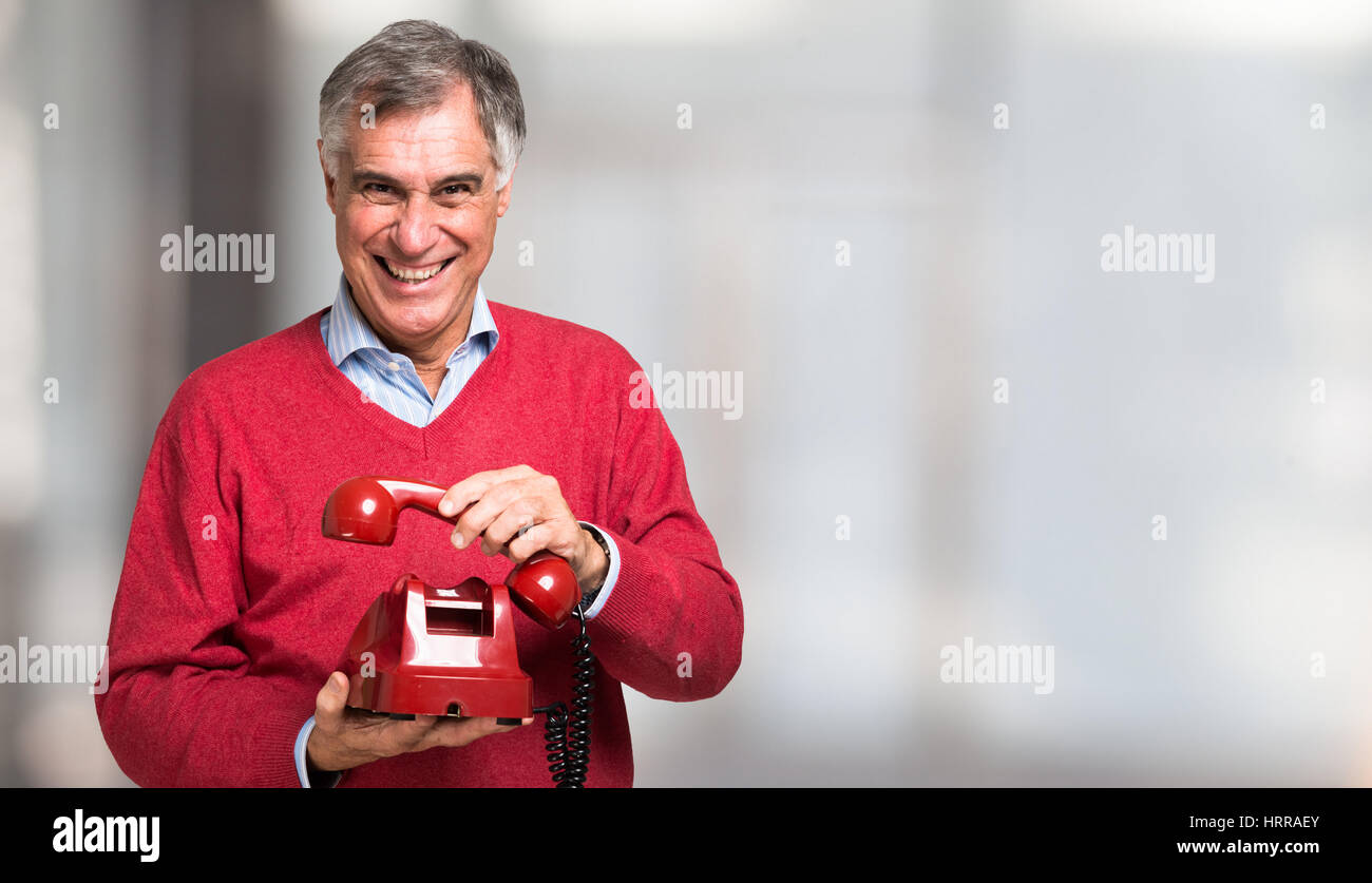 Man Using Red Telephone Man using a red vintage telephone Stock Photo - Alamy