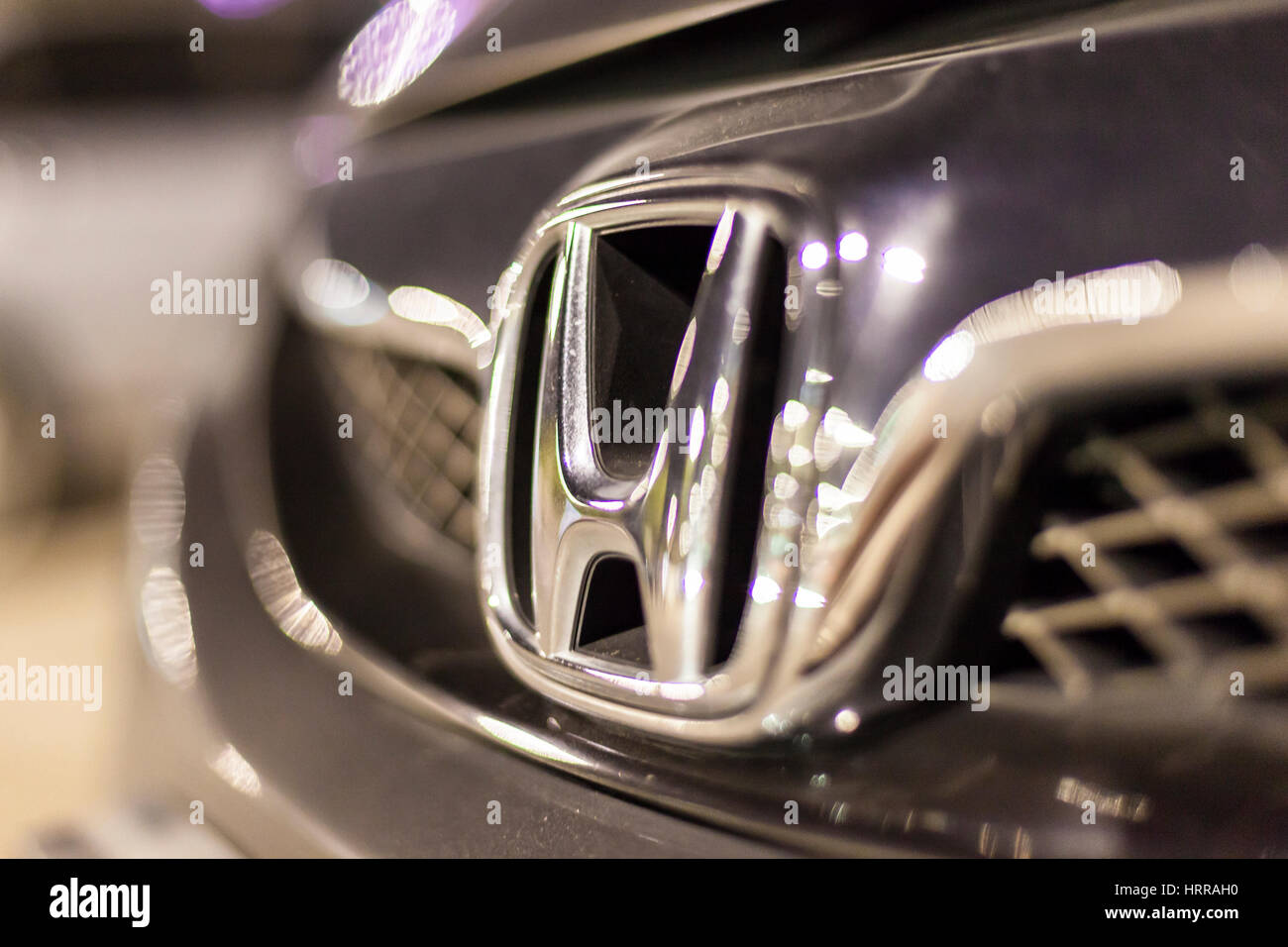 ABU DHABI, UAE - NOV 26, 2016: Honda company logo on a car illuminated at night Stock Photo