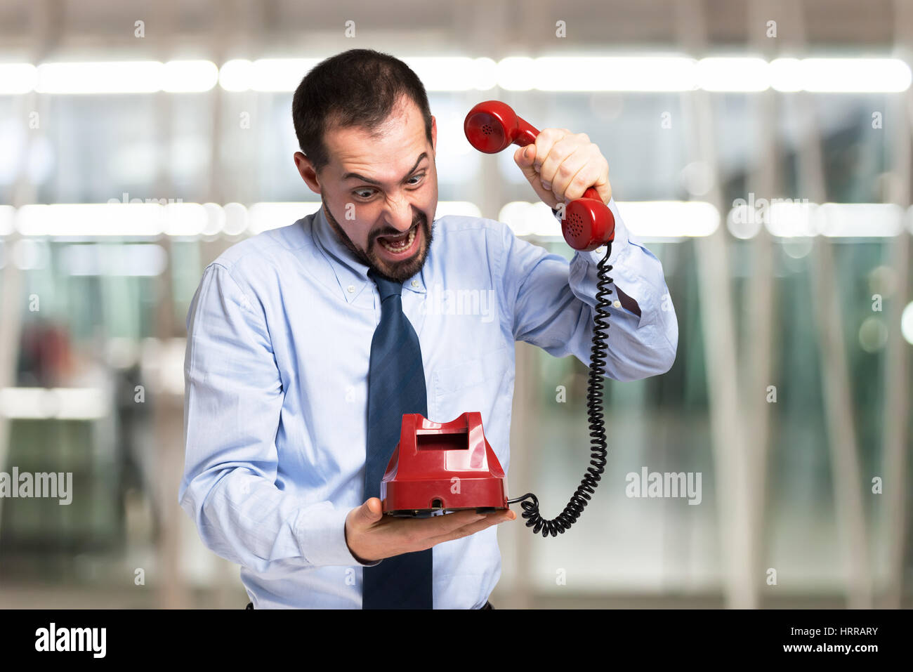 Angry man hanging the telephone down Stock Photo Alamy