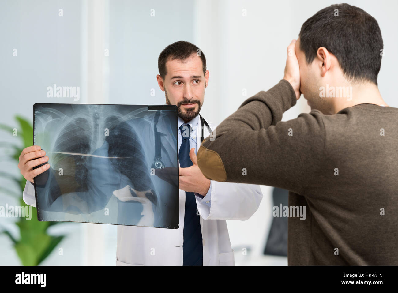 Doctor showing radiography to a desperate patient Stock Photo