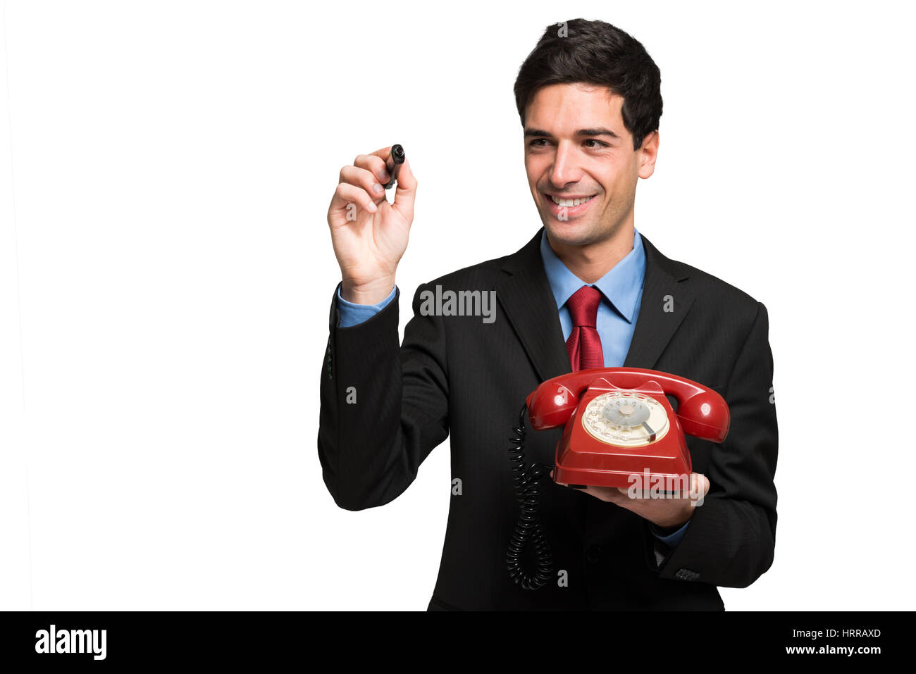 Businessman using a pen while holding a telephone Stock Photo Alamy