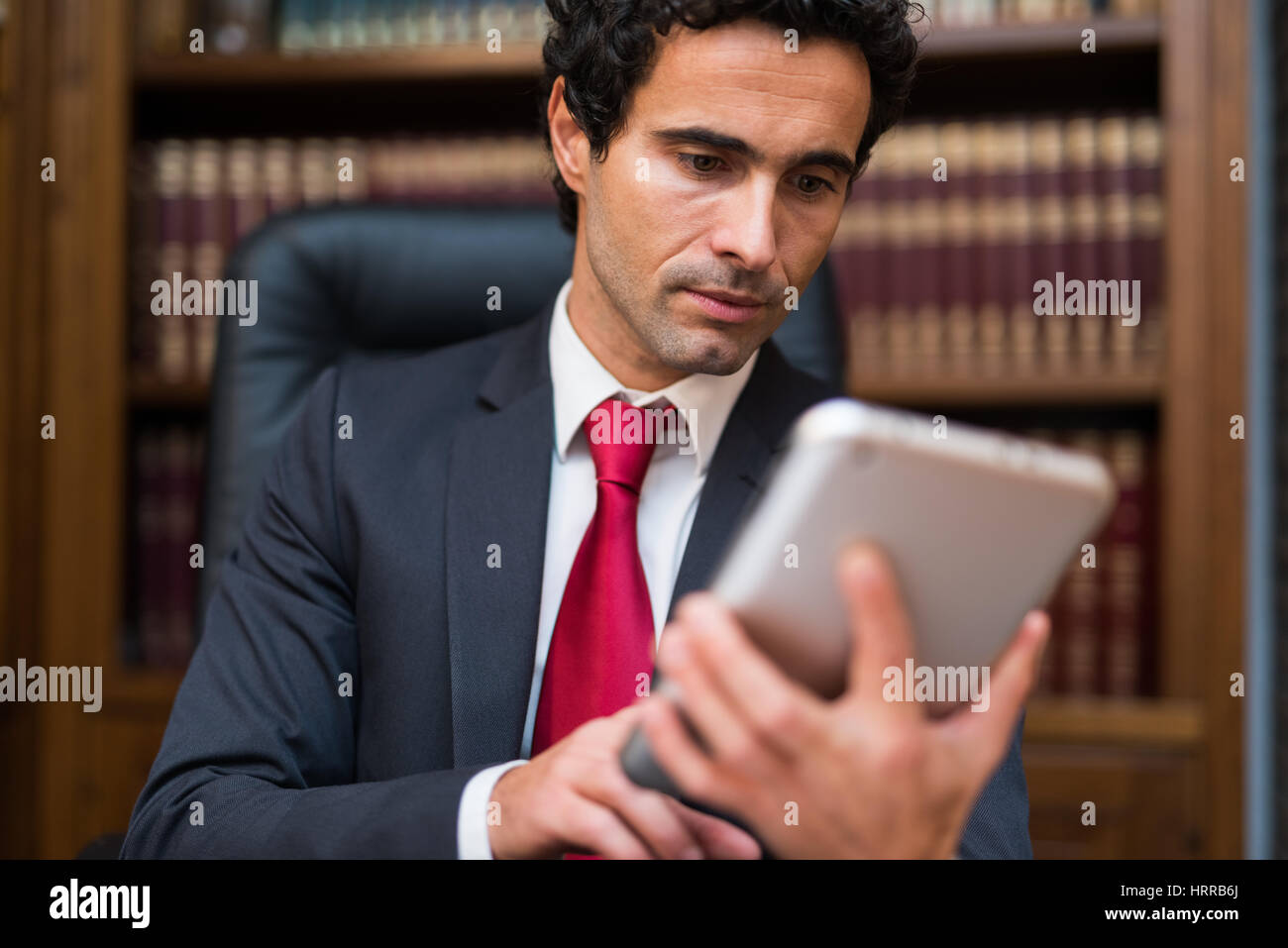 Businessman using his tablet Stock Photo - Alamy