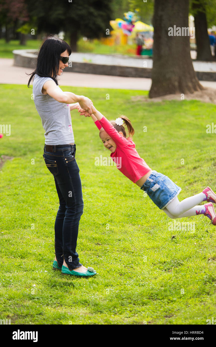 https://c8.alamy.com/comp/HRRBD4/happy-family-of-mom-and-daughter-cheerfully-spinning-around-together-HRRBD4.jpg