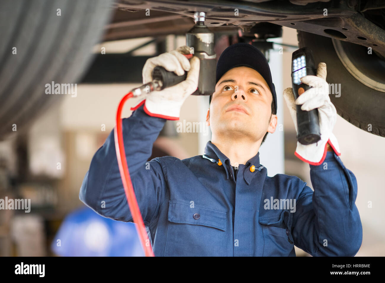Portrait of a mechanic repairing a car in his garage Stock Photo - Alamy