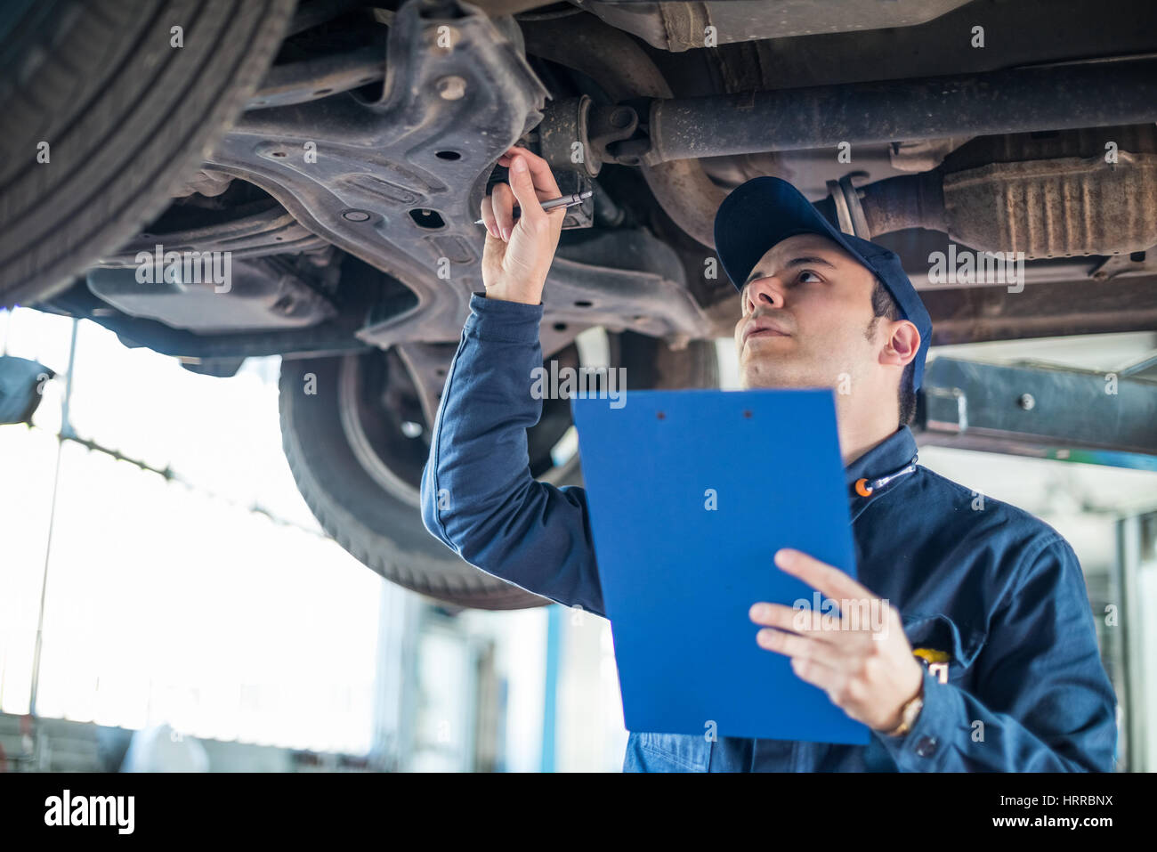 Portrait of a mechanic at work in his garage Stock Photo - Alamy