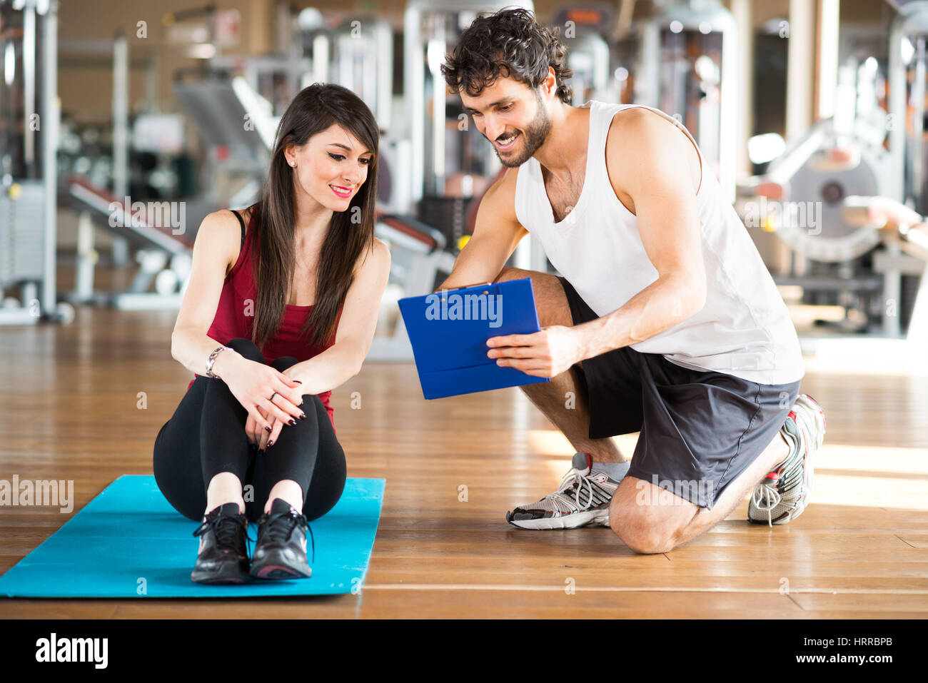 Woman reading her training program in a gym Stock Photo Alamy