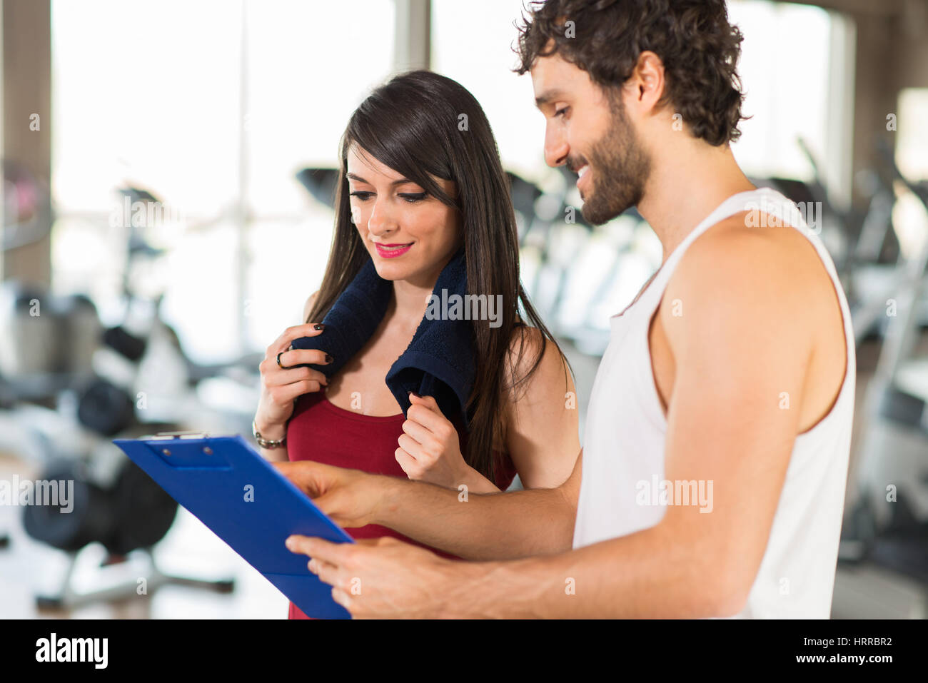 Woman reading her training program in a gym Stock Photo Alamy
