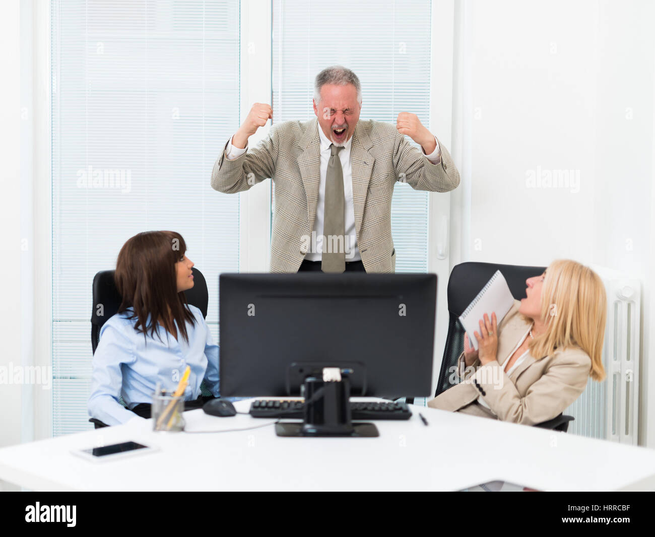 Businessman shouting at his employees Stock Photo