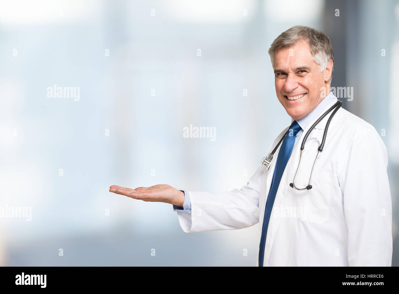 Senior doctor presenting and showing copy space for product or text Stock Photo