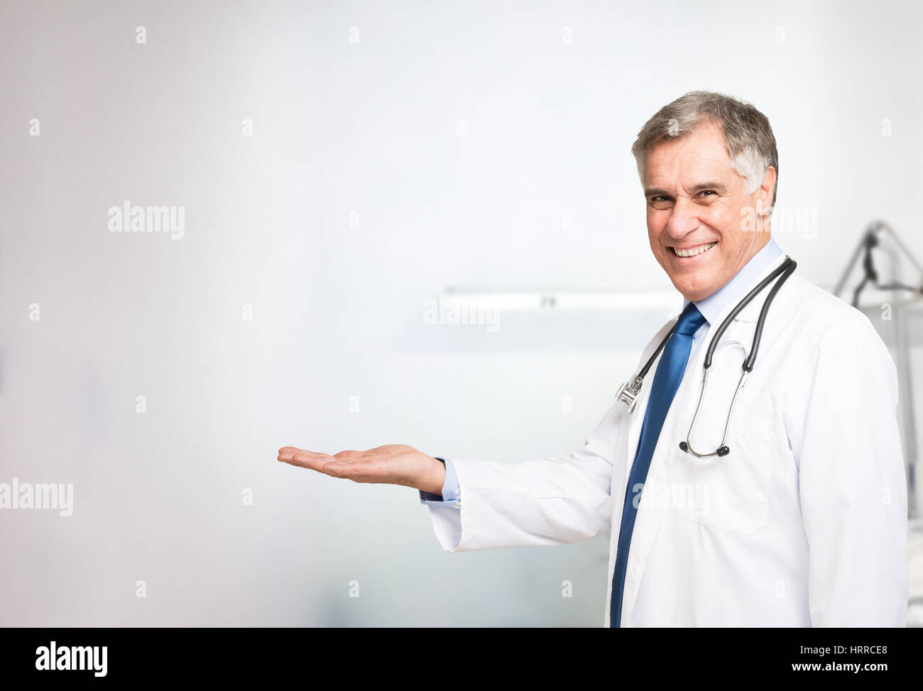Senior doctor presenting and showing copy space for product or text Stock Photo