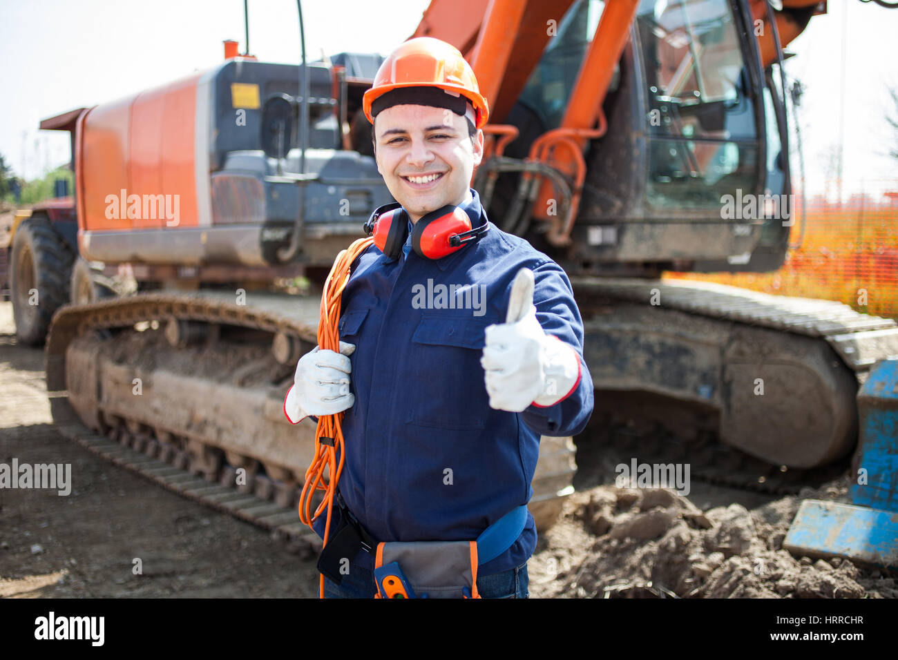 Portrait of an happy worker in a construction site Stock Photo - Alamy