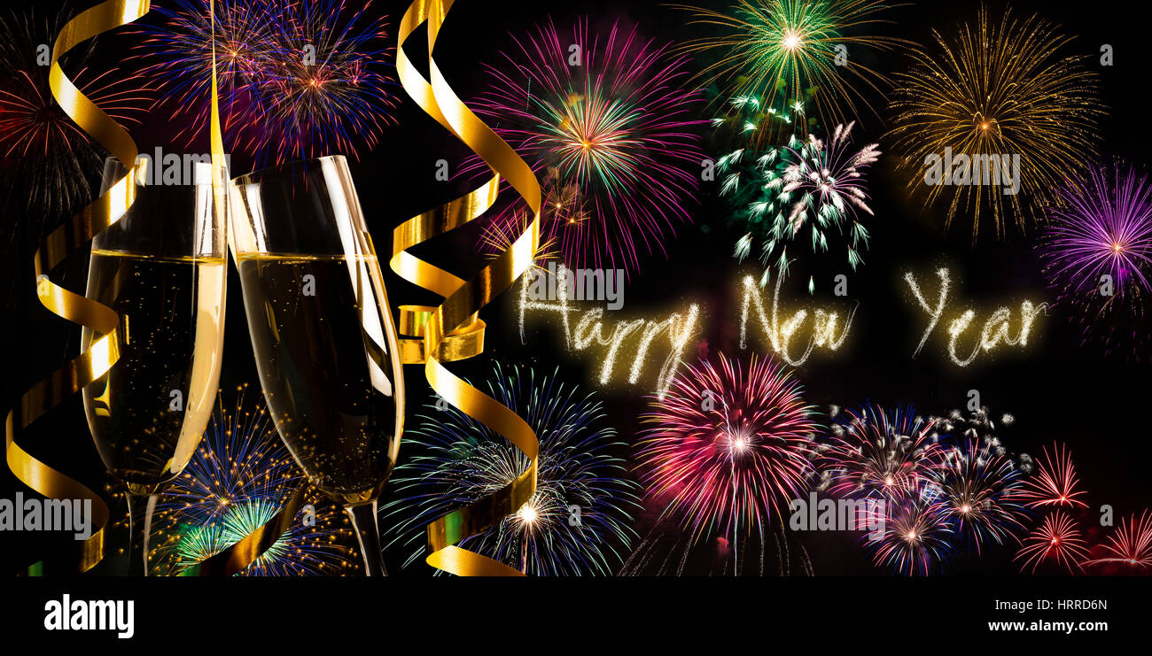 Happy New Year text, champagne flutes and fireworks Stock Photo - Alamy